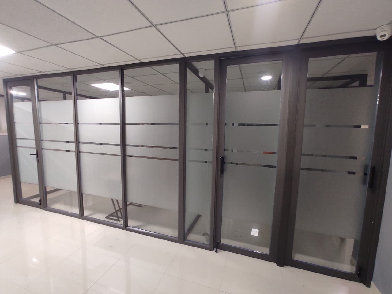 Row of glass-partitioned cabins with sliding doors