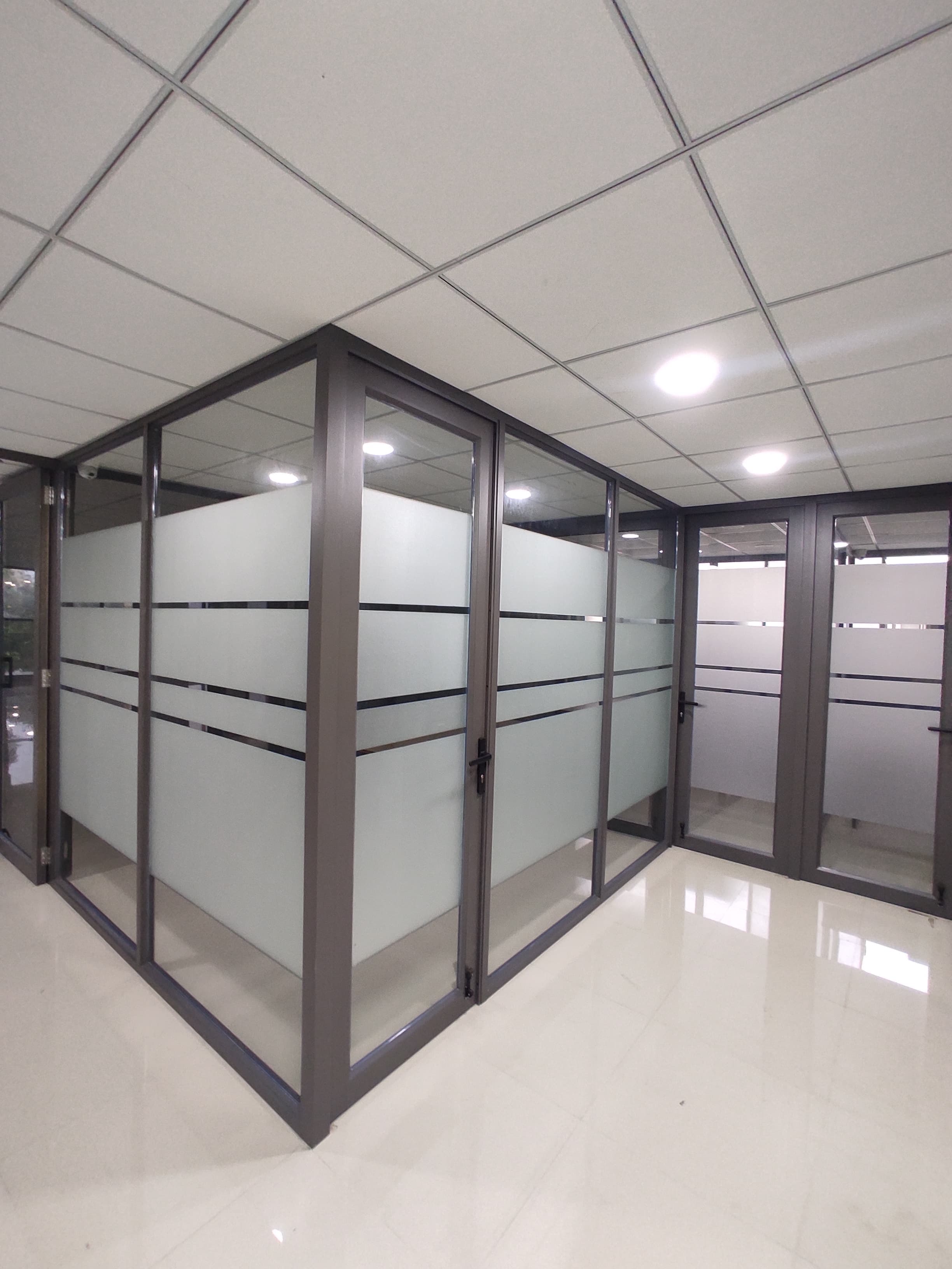 Block of glass-walled cabins on the office floor