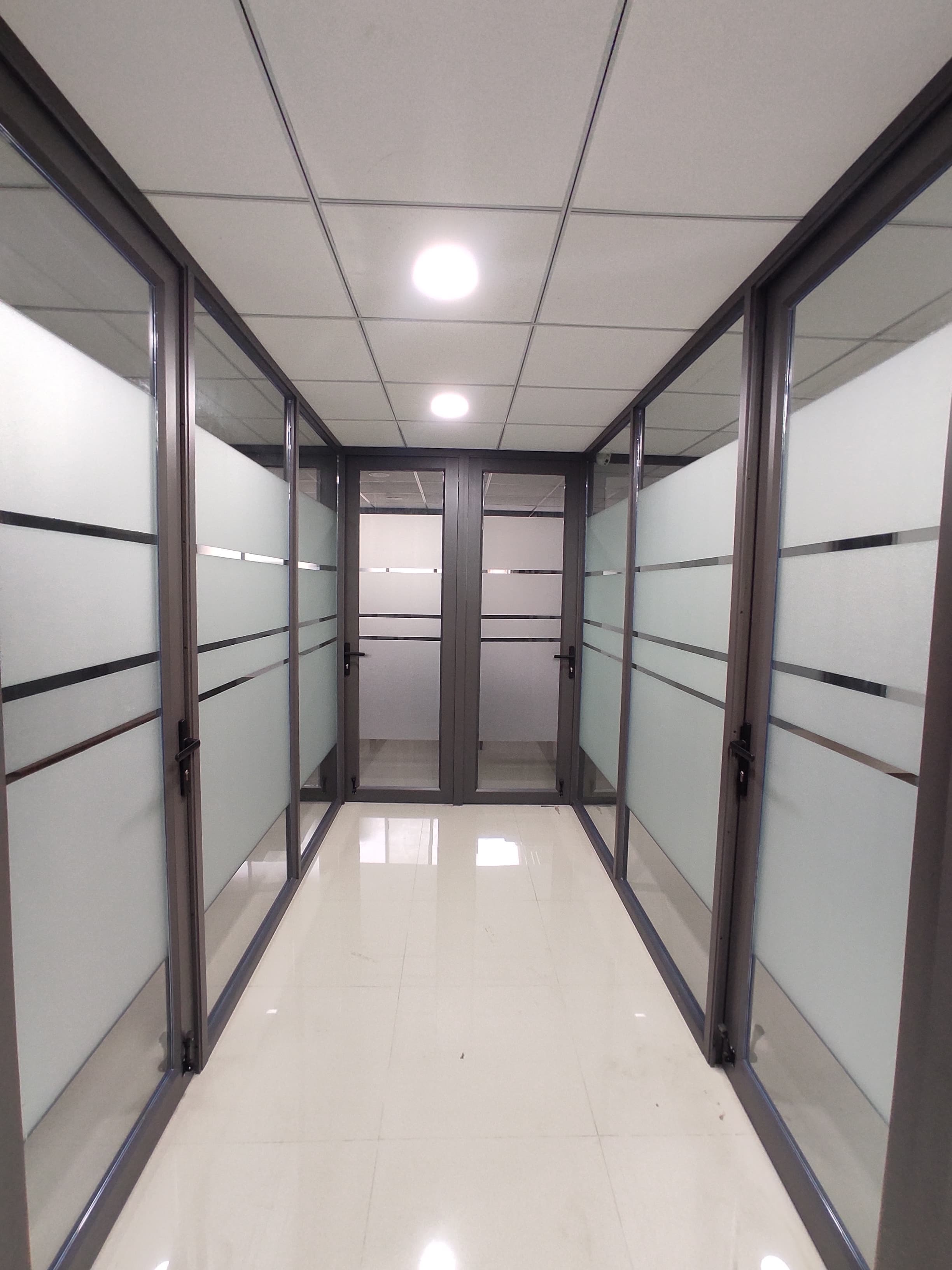 Walkway between glass cabins leading to more cabins